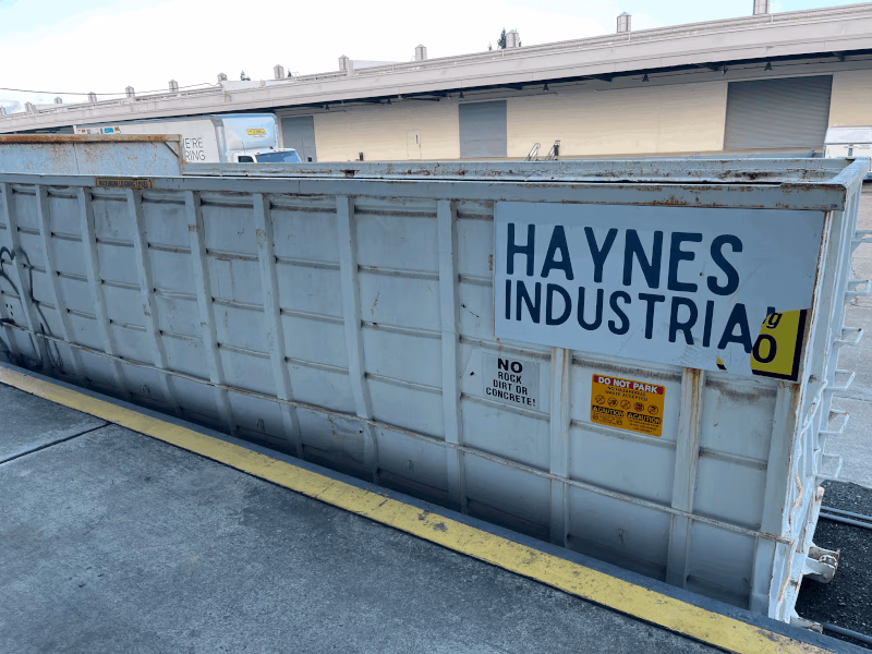 Haynes Industrial branded roll-off dumpster container at an industrial facility