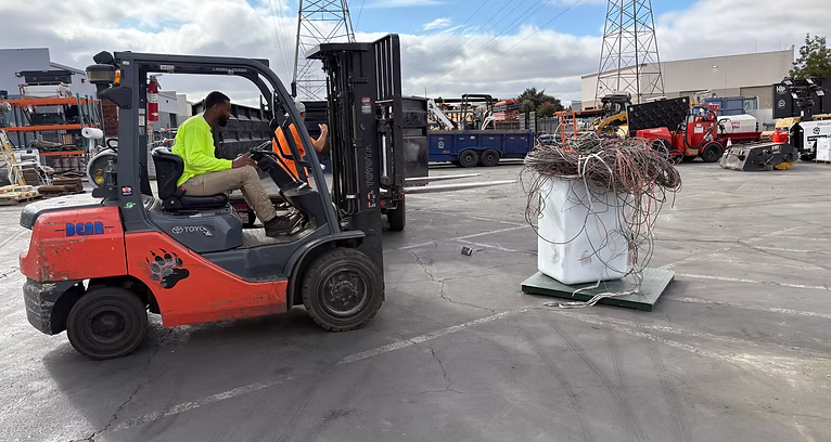Forklift moving industrial surplus material