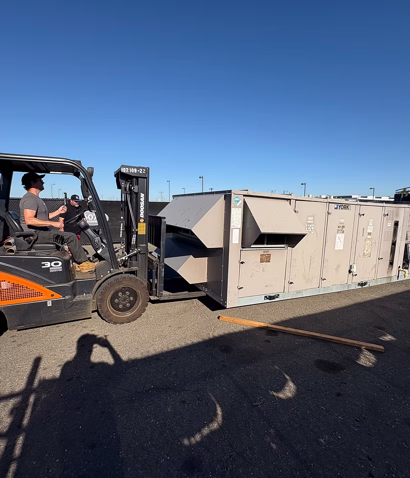 Commercial HVAC unit staged for removal and recycling