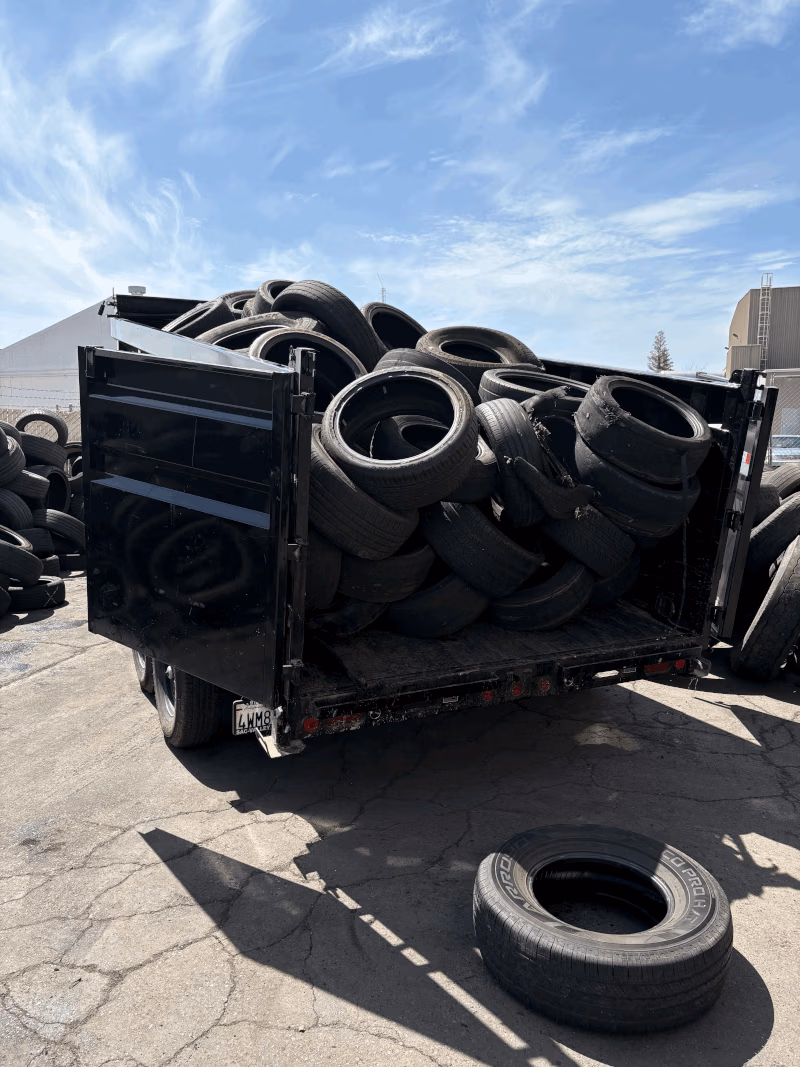 Dump trailer loaded with scrap tires at a tire yard